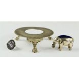 A silver and amethyst dress ring, white metal elephant pin cushion and a silver plated stand.