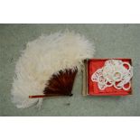 A faux tortoiseshell and ostrich feather fan, and lace napkin rings.