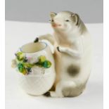 A porcelain pig posy holder, circa 1920, 13cm high.