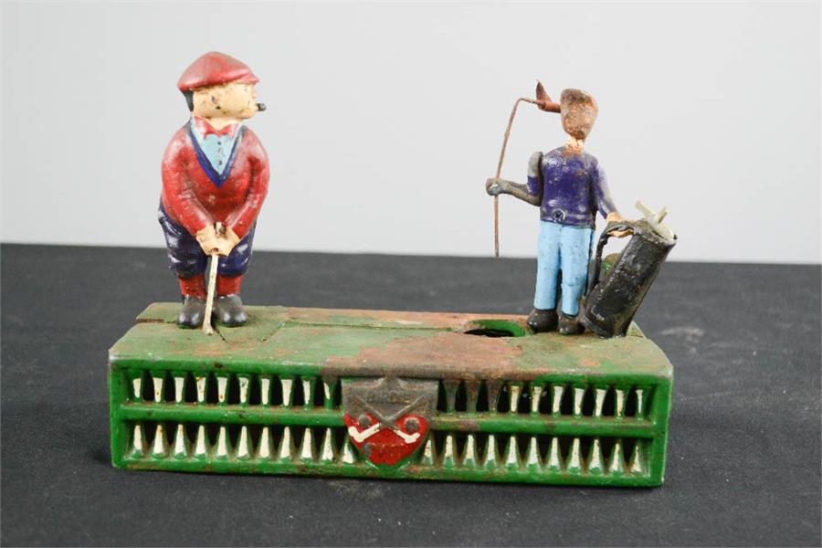 An antique painted metal money box with golfing figures to the top. - Bild 2 aus 2