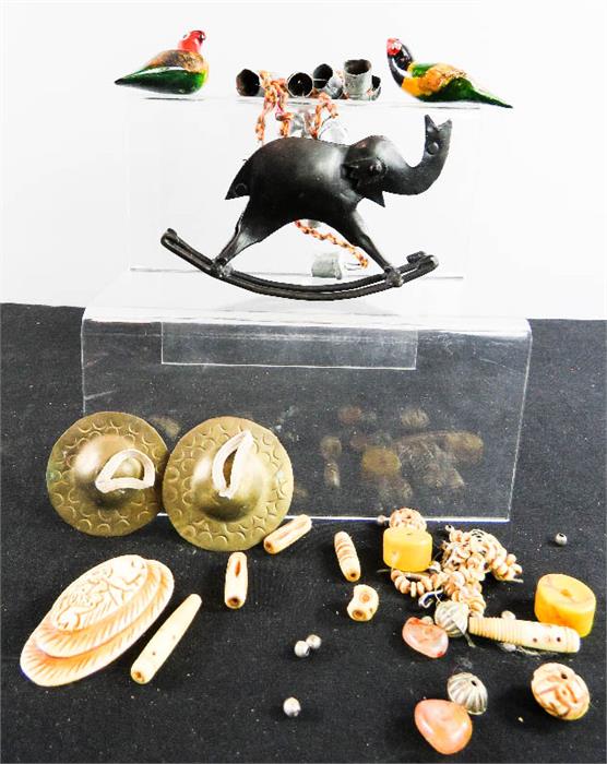 Two wooden carved and painted parrots, bone carved trinkets and beads, pair of symbols, and an