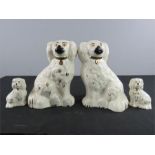 Two pairs of miniature Staffordshire dogs.