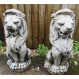 A pair of reconstituted stone garden lions.