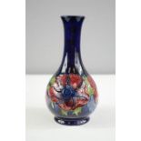 A Moorcroft vase, baluster form in the poppy pattern, impressed to the base, 16cm high.