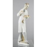 A Lladro figure; vet with puppy, 23cm high.