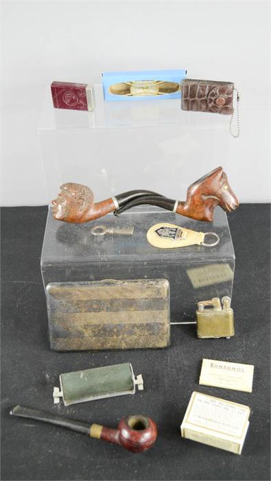 A quantity of tobacconist items including three pipes, zippos and other items.