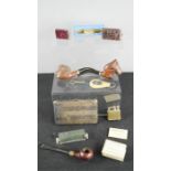 A quantity of tobacconist items including three pipes, zippos and other items.