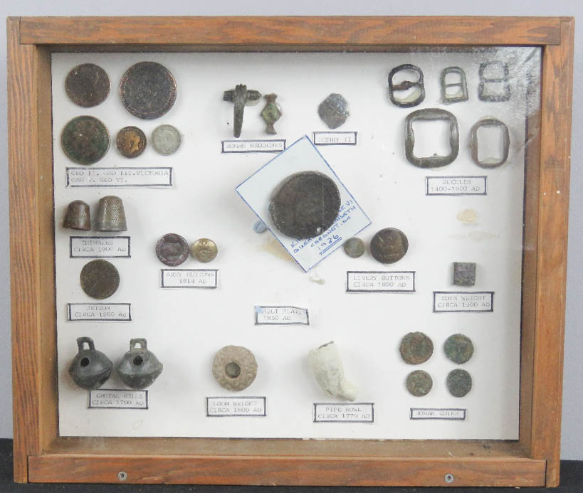 A display box containing excavated items.