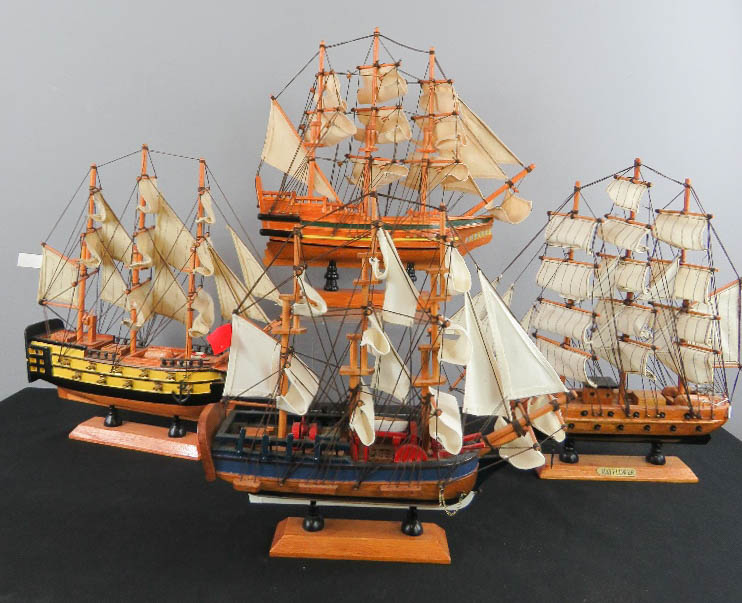 A group of four model sailing ships.