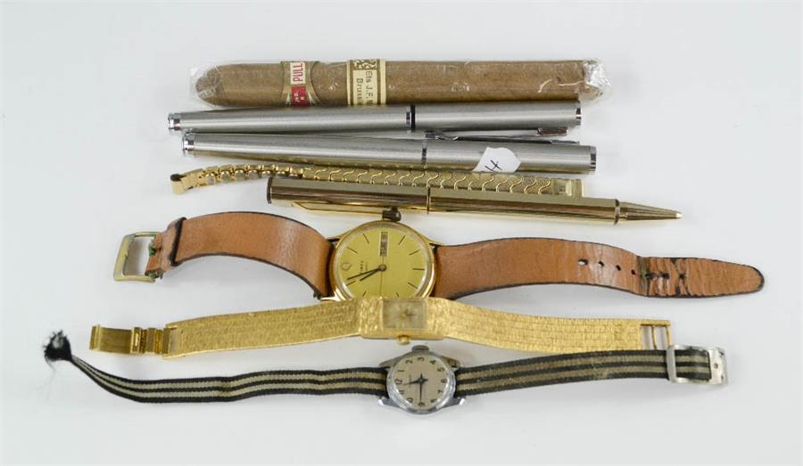 Three watches, three pens and a King Edward cigar.