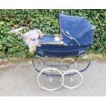 A Silver Cross pram in blue.