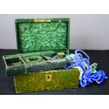 A leather box containing costume jewellery.