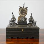 An ebony 19th century inkwell, carved with elephants, finials and bearing bone inlaid decoration.