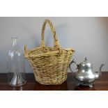 A glass jar together with a silver plated tea pot and a wicker basket.