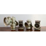 Four vintage bicycle lamps; three clip on examples with convex lenses.