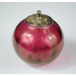 A cranberry glass and silver lidded jar.