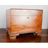 A cedar wood cigar humidor, with a fitted interior, raised on ogee bracket feet, 30 by 38 by 27cm.