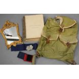 A Royal Drawing Room table book, a metal gilt mirror, a satchel, nurses belt, and a Fornum & Mason