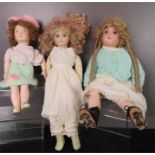 Three porcelain headed dolls, wearing hand made clothes.