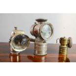 Three Vintage bicycle lamps including Premier and Mada examples.