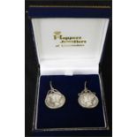 A pair of silver Liberty coin earrings.