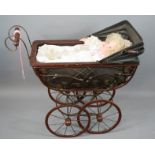 A Vintage dolls pram, together with porcelain doll dressed with bonnet.