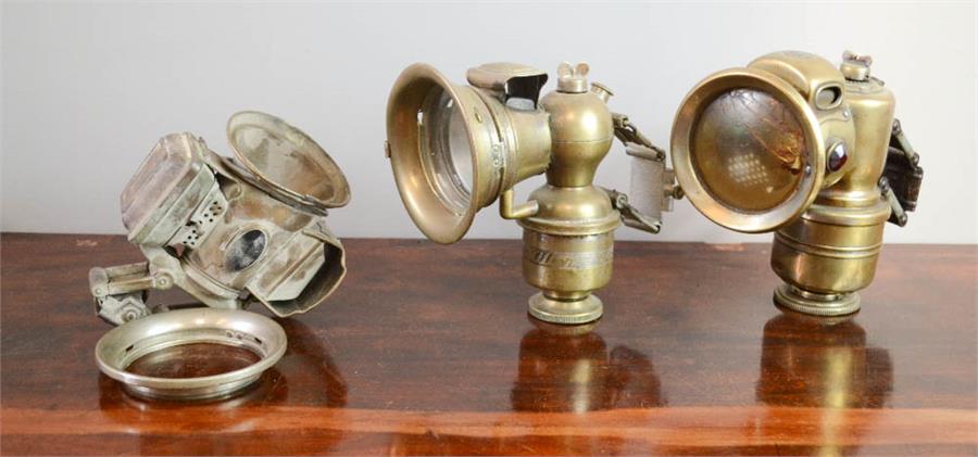 Three vintage bicycle lamps including Bauer with convex lens, and a Joseph Lucas Galcia Club lamp.