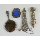 A miniature silver hand mirror, a silver match holder, miniature silver frame, scissor holder etc.