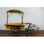 A vintage model bicycle vendor stall 'Flowers & Plants', hand painted with detail, 46cm high.