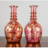 A pair of Turkish cranberry glass decanters, embellished with gilding, late 19th century.