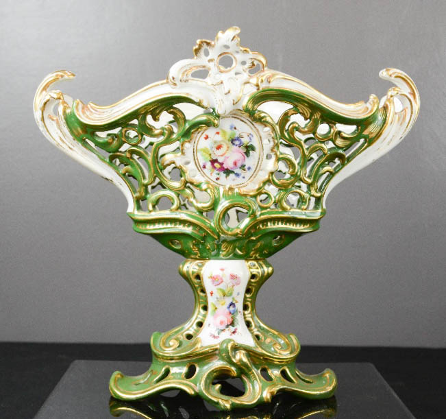 A hand painted porcelain pierced comport depicting flowers, possibly Hungarian, 24cm high.