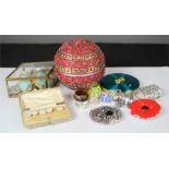 A glass box containing jewellery, a compact, beaded sphere box and other items of jewellery.