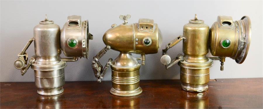 Four bicycle lamps; including Miller Carbo British Made and other examples.