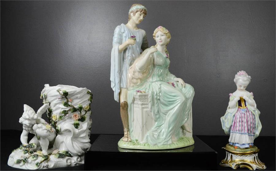 Three porcelain figures; cherub vase, girl with flower, and two lovers.