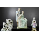 Three porcelain figures; cherub vase, girl with flower, and two lovers.