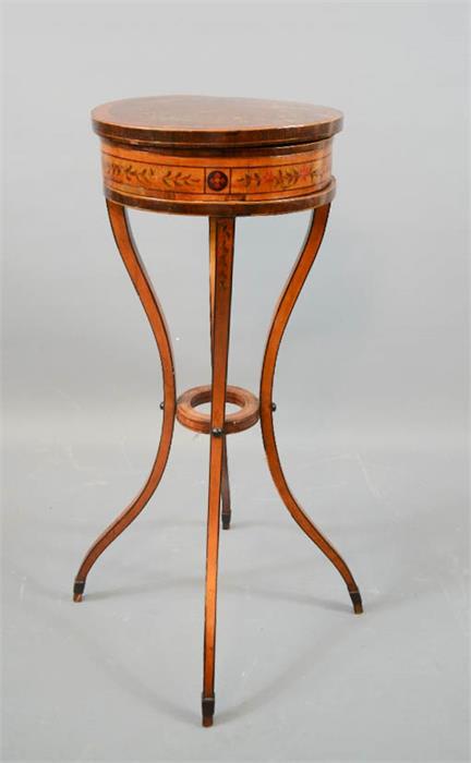 A 19th century satinwood French sewing box on stand, painted with flowers, the revolving circular