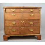 An 18th century mahogany bachelors chest, with folding top, one long drawer over two short and two