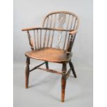 A 19th century Windsor armchair, with pierced splat, bow arm pierced with spindles and H form