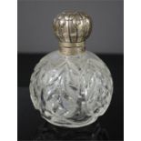 A 19th century silver and glass dressing table bottle.