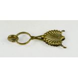 A Victorian brass skirt lifter, foliate motif.