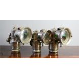 Three vintage bicycle lamps.