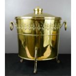 An Art Nouveau brass coal bucket raised on three feet.