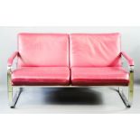 A mid-century purple leather two seater settee with chrome frame.