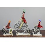 Three Italian ceramic model Penny Farthings bicycles and their riders.