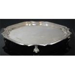 A silver salver raised on four feet, 11.8toz.