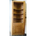 A large antique pine corner cupboard.