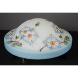 A vintage glass ceiling shade with floral decoration.