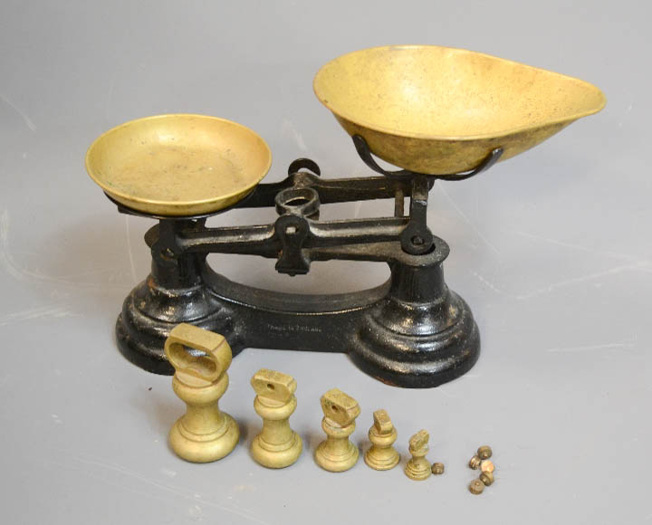 A cast iron and lacquered set of brass scales, complete with original weights.