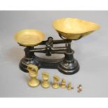 A cast iron and lacquered set of brass scales, complete with original weights.