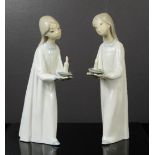 A pair of Lladro figures of two young girls holding chamber sticks, 21cm high.
